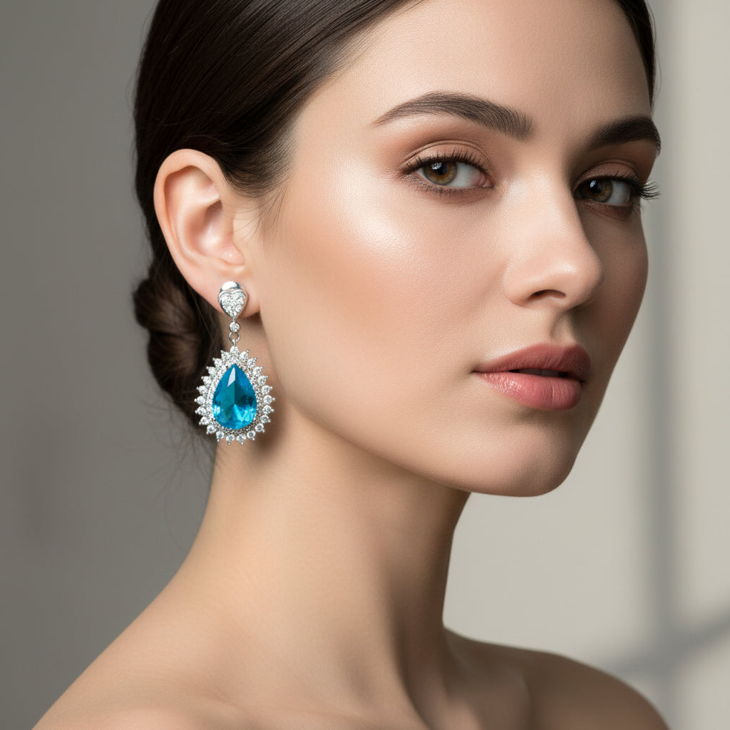 A pair of ocean blue earrings with a geometric pattern and rhodium plating, designed with American diamonds.